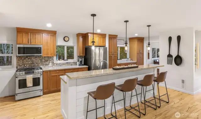 This kitchen is a delight to cook in with the Cafe range, expansive granite countertops and smart design.