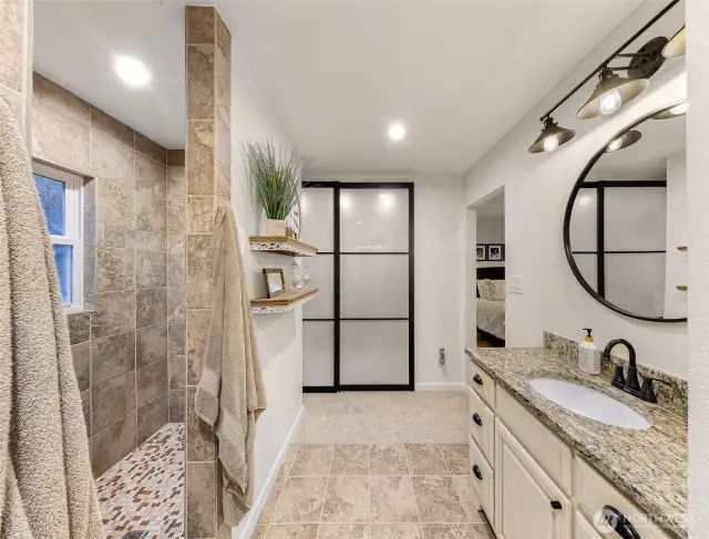 Behind those frosted glass doors is a huge walk-in closet; sized for two. The walk-in shower on the left is much, much more spacious than it looks here. Even with the built-in step/seat there is room for a shower dance party here.