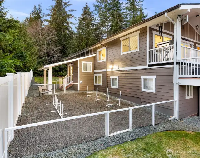 This back/side yard area is extremely useful. The covered area to keep you dry, the low fence to keep "them" in. The 6' solid PVC fence to keep "them" on your property (this is the same low, low maintenance fencing all over the property).   Ideal for pets or what ever you have that you don't want out running.