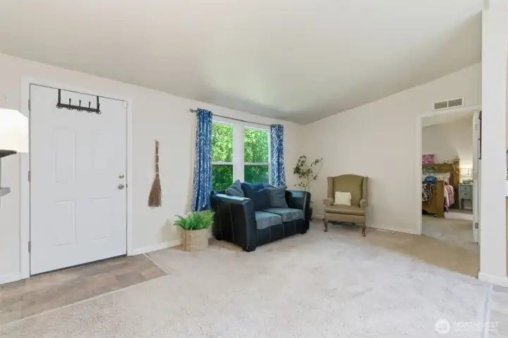 Enter into the family room with vaulted ceilings