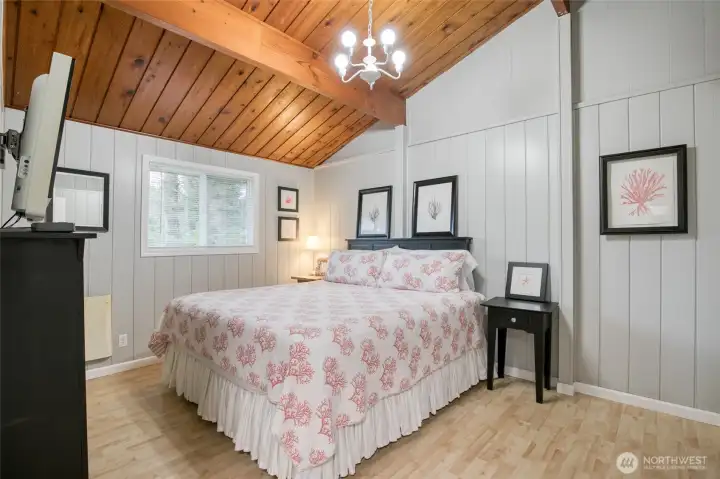 Primary bedroom with plenty of room for king size bed and featuring those beautiful pine ceilings