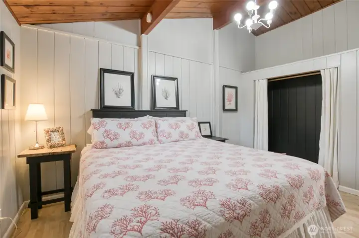 Primary bedroom with vaulted ceilings and large closet