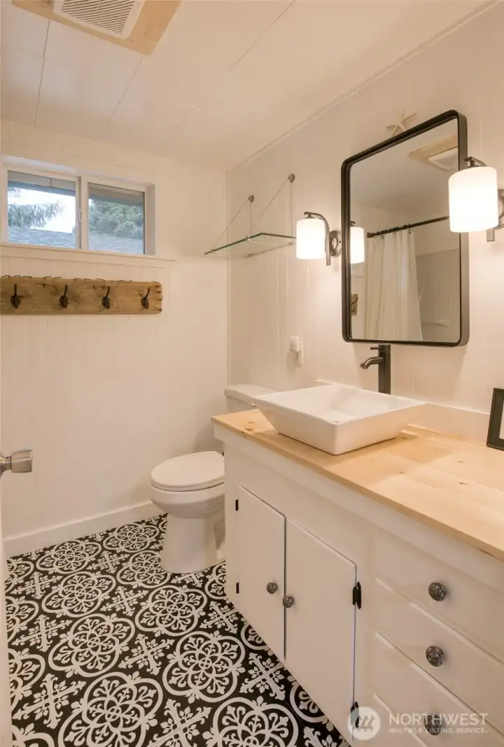 Completely updated bathroom - new floor, countertops, light fixture, faucet & sink