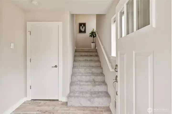 Entry Foyer & Staircase to Living Space ~ Garage Entrance just out of view on the left.