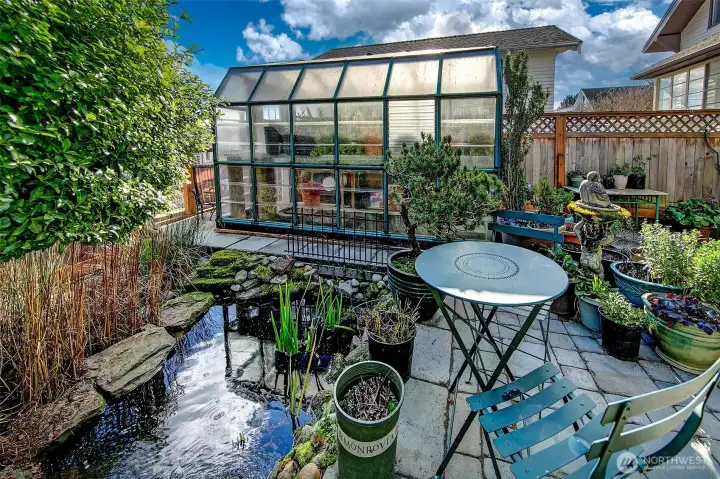 Back yard ponds and waterfalls, with glorious plantings and an amazing greenhouse.