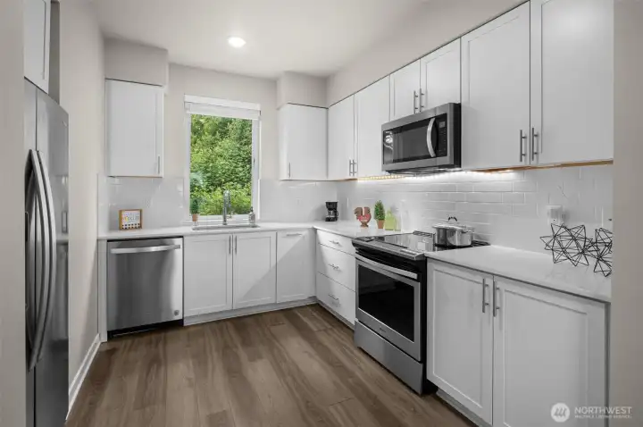 Spacious kitchen comes complete with quartz counters, all stainless appliances stay, soft close drawers and cabinets. Plus under cabinet lighting.