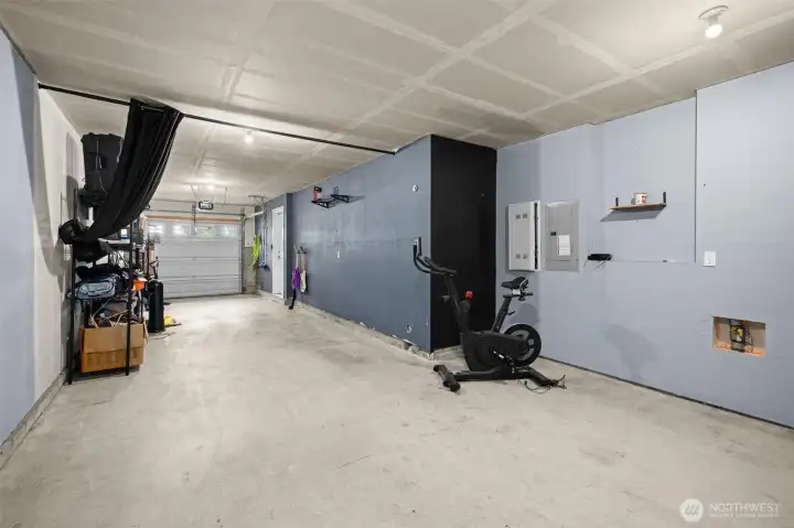 2 car tandem garage with extra space for storage of a work bench.