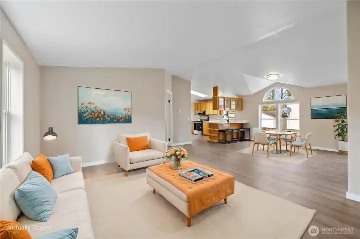 Virtually staged photo looking toward the kitchen from the front door