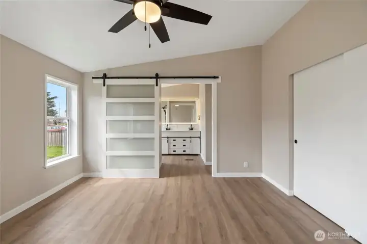 Primary bedroom looking toward the updated 3/4 bathroom