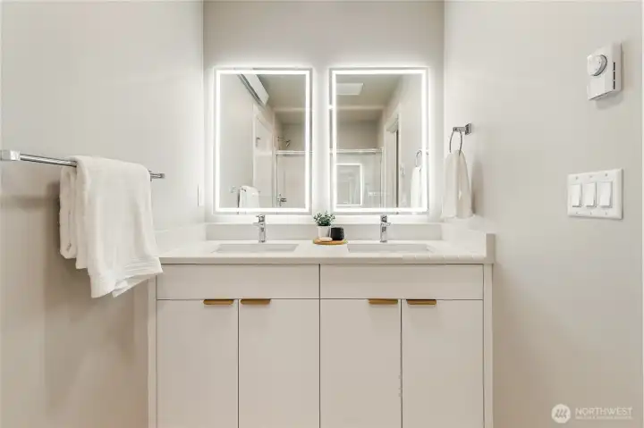 Primary ensuite with double sinks & lit mirror