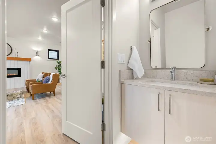 Powder room thoughtfully located away from entertaining areas for added privacy