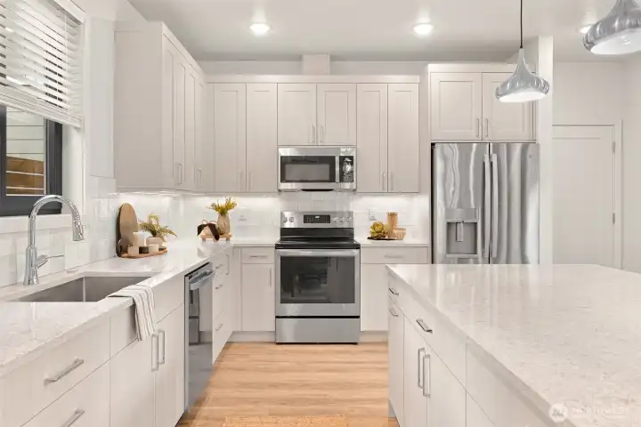 Kitchen featuring quartz countertops and a stylish tile backsplash