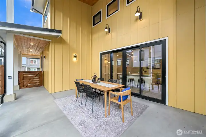 Exterior covered patio with soaring ceilings, creating an additional outdoor living space