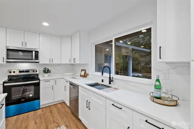 The sink has goose neck faucet, with built in cutting board and dish drying rack. NICE!!