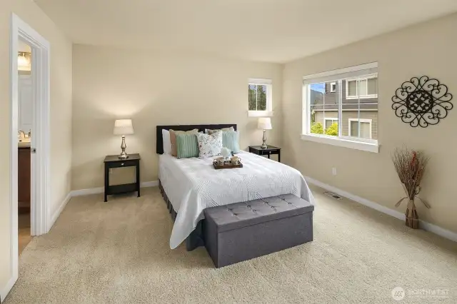 Primary suite with a private bathroom offers respite at the end of the day.