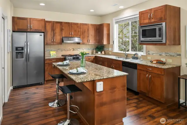This kitchen will delight any chef with its center island and stainless appliances.