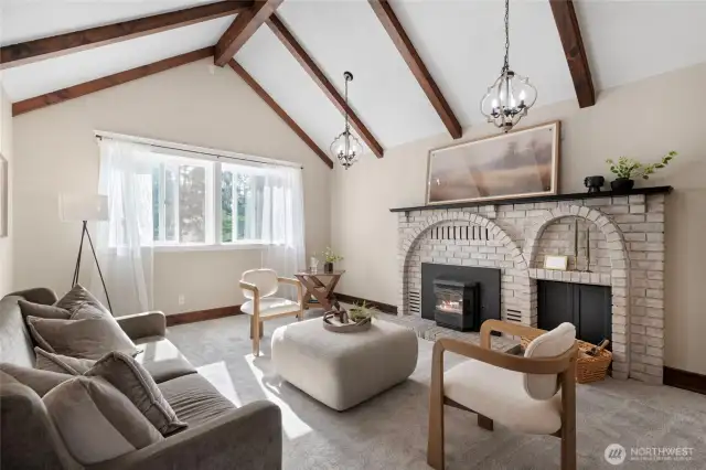 The beautiful brick, wood burning fireplace is definitely one of the main focal points of this stunning living room.