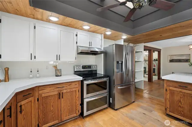 Wood paneled ceiling, enormous vaulted skylight, and white concrete counters makes this kitchen a one of a kind.
