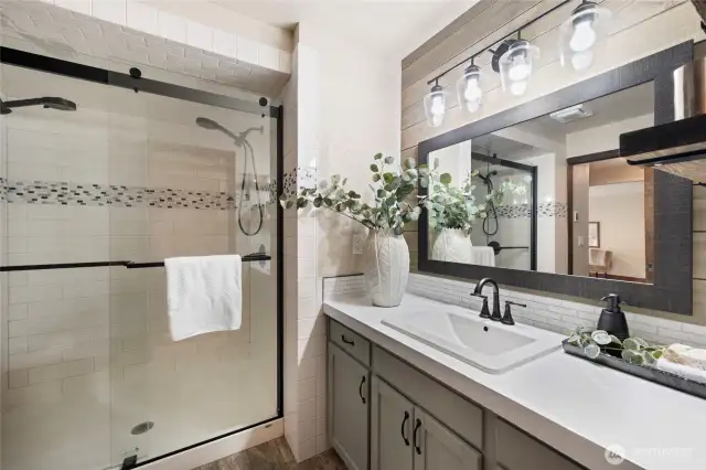 This bathroom serves primary bedroom one and connects to the main hallway.