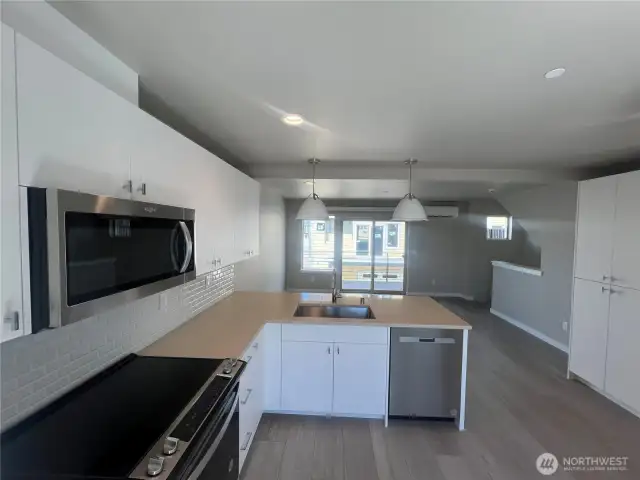 Bright and open floor plan with slider leading to spacious deck