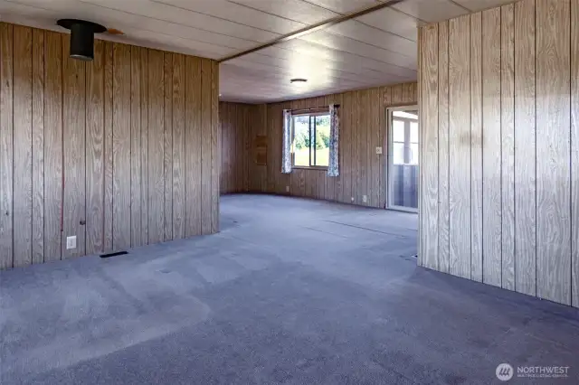 The front door opens to a large living and dining area.