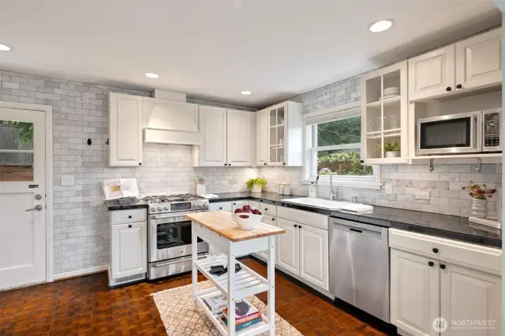Exterior door from kitchen leads directly to backyard brick patio