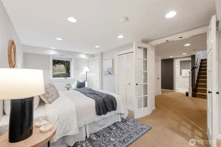 Charming French doors open up from this large bedroom into the downstairs landing