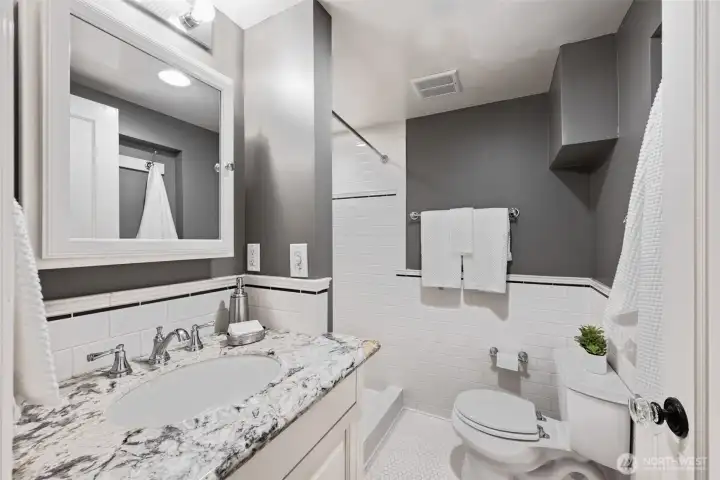 Updated, lovely 3/4 bath downstairs w/tile everywhere