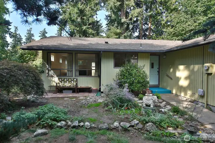 One of the best features of this home is the level lot w/mature landscaping and the privacy it provides. A sweet covered patio, too! The 2 large windows are to the open living/dining room. Smaller window is your kitchen sink window! This is the east side of the home.