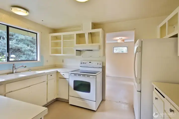 Doors to cabinets are available. There is vinyl flooring in the kitchen and both bathrooms. The rest of the home is ready for new flooring.