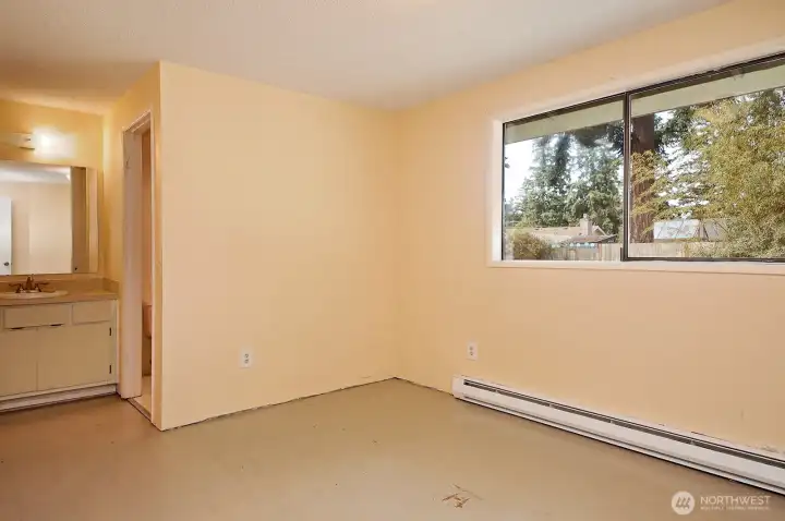 This is the Primary Bedroom that looks out upon your back yard. Bathroom is to the right of the sink and a walk-in closet is to the left of the sink.