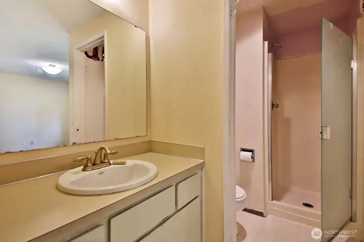 3/4 Primary Bathroom. There is vinyl flooring in the bathroom.