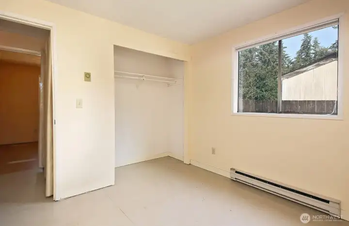 Bedroom #3 with window along the north side of the home. Bedrooms #2 and #3 are located across from each other.