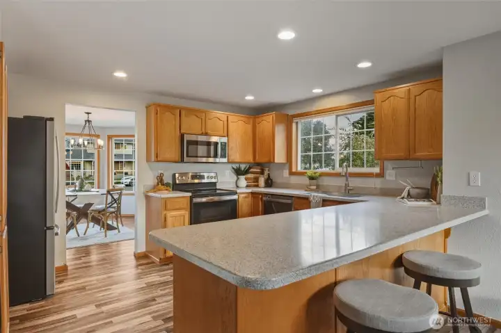 Spacious kitchen with plenty of counter space (with an eat-in bar) and stainless steel appliances.