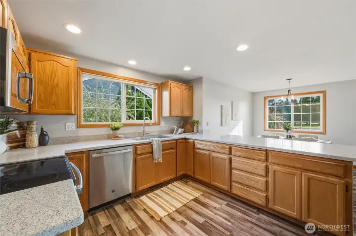 Looking at the kitchen toward the bar and informal dining space beyond.