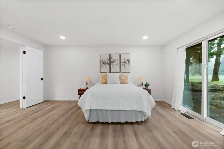 Primary suite with sliding door to the patio