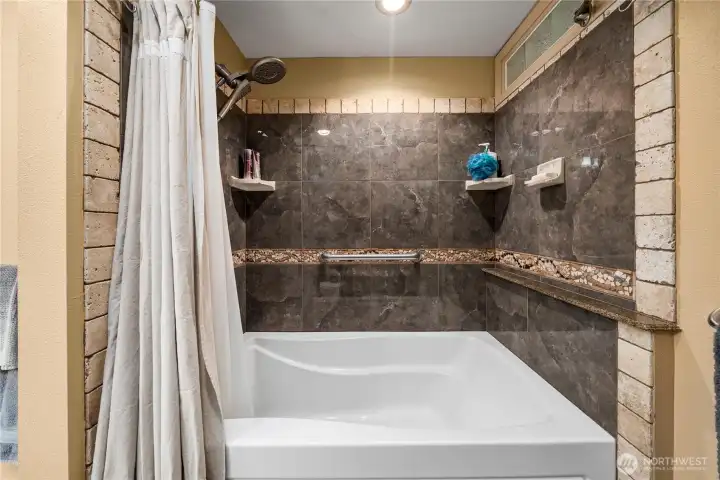 Combination shower/soaking tub in primary ensuite.