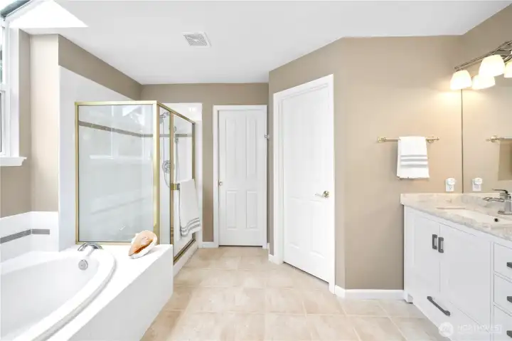Primary ensuite bath with walk in closet and separate toilet