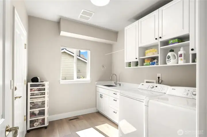Spacious laundry room with a soaking sink