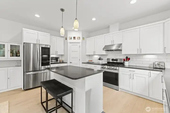 Chef's dream kitchen complete with gas stove, island, and large walk-in pantry
