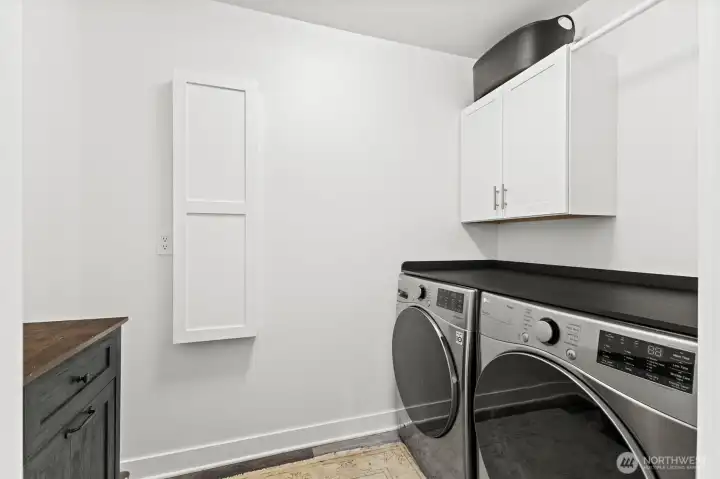 Laundry room upstairs right near the bedrooms with ironing station and room to fold