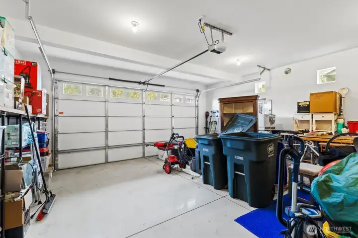 2 car garage with upgrade expoxy paint, workbench, and wall mounted tool rack