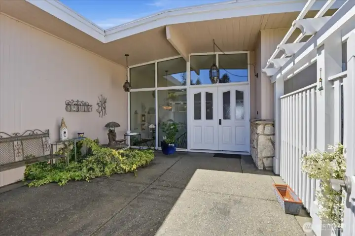 Entry with fenced courtyard.