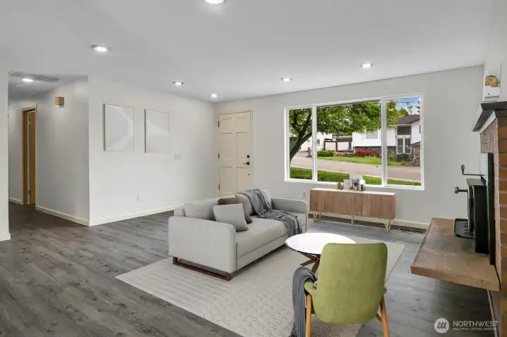 Living room virtually staged to highlight how the floorplan lives — brightened by natural light from the south-facing window Living room virtually staged to highlight how the floorplan lives — brightened by natural light from the south-facing window