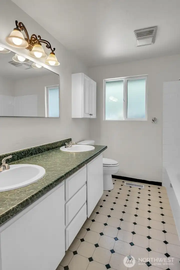 The main bath features a double vanity and a convenient bath/shower combo The main bath features a double vanity and a convenient bath/shower combo