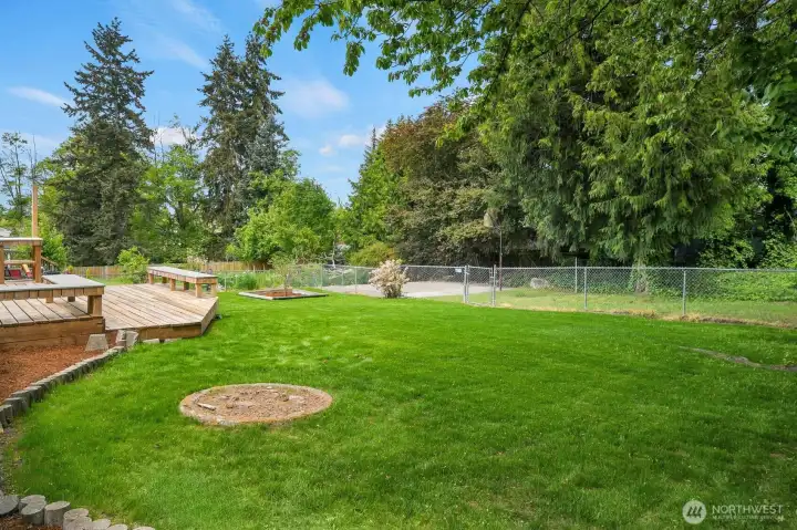Enjoy a large, level lot featuring garden spaces, mature trees, a cozy firepit area, and an additional gated section with a level pad perfect for entertaining, projects, or creative possibilities. Enjoy a large, level lot featuring garden spaces, mature trees, a cozy firepit area, and an additional gated section with a level pad perfect for entertaining, projects, or creative possibilities.