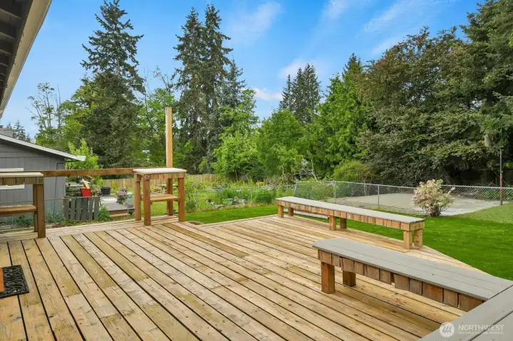 A well-maintained three-tiered deck provides generous space for entertaining, relaxing, and enjoying backyard activities A well-maintained three-tiered deck provides generous space for entertaining, relaxing, and enjoying backyard activities