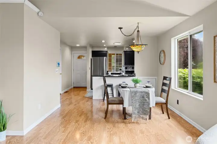 Dining Space with open concep0t and vaulted ceilings.