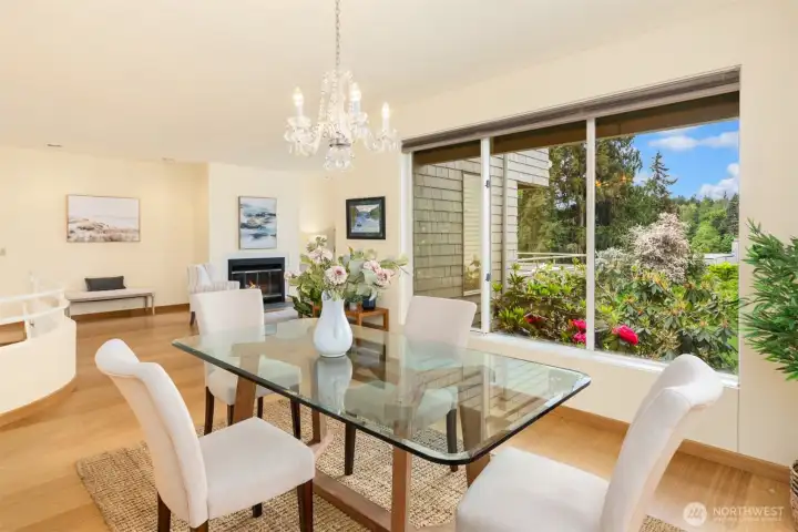Fabulous views from the dining area opens to the living room with a cozy woodburning fireplace.