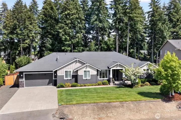Rare rambler retreat with striking curb appeal, mature landscaping, and timeless Craftsman-inspired design.